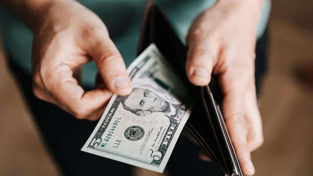 Man holding wallet with money