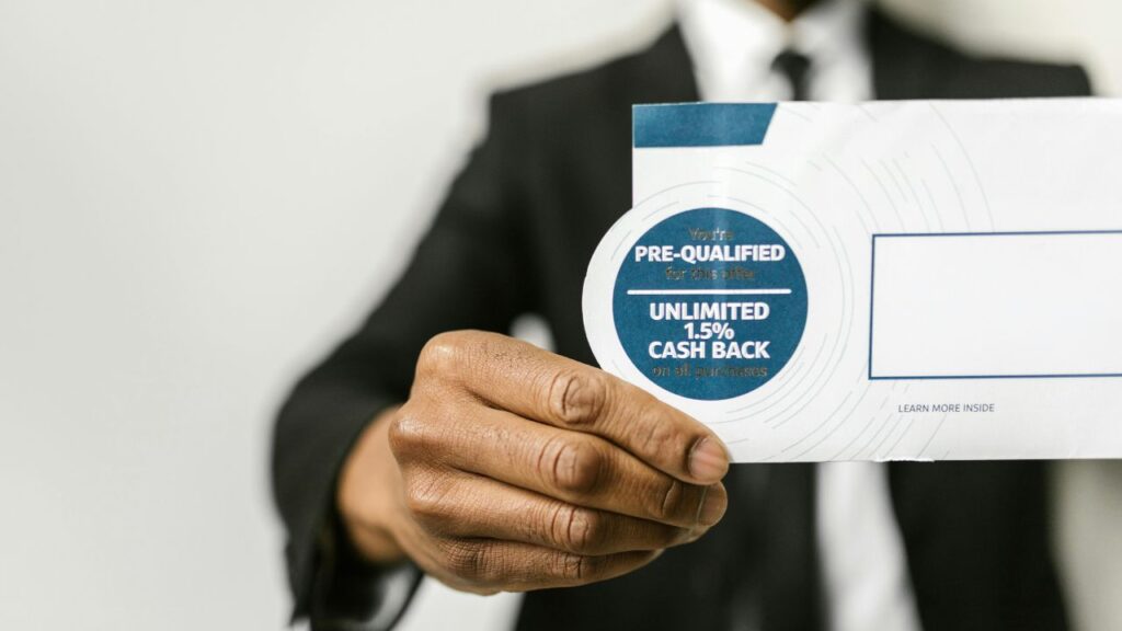 Person in Black Suit Holding an Envelope