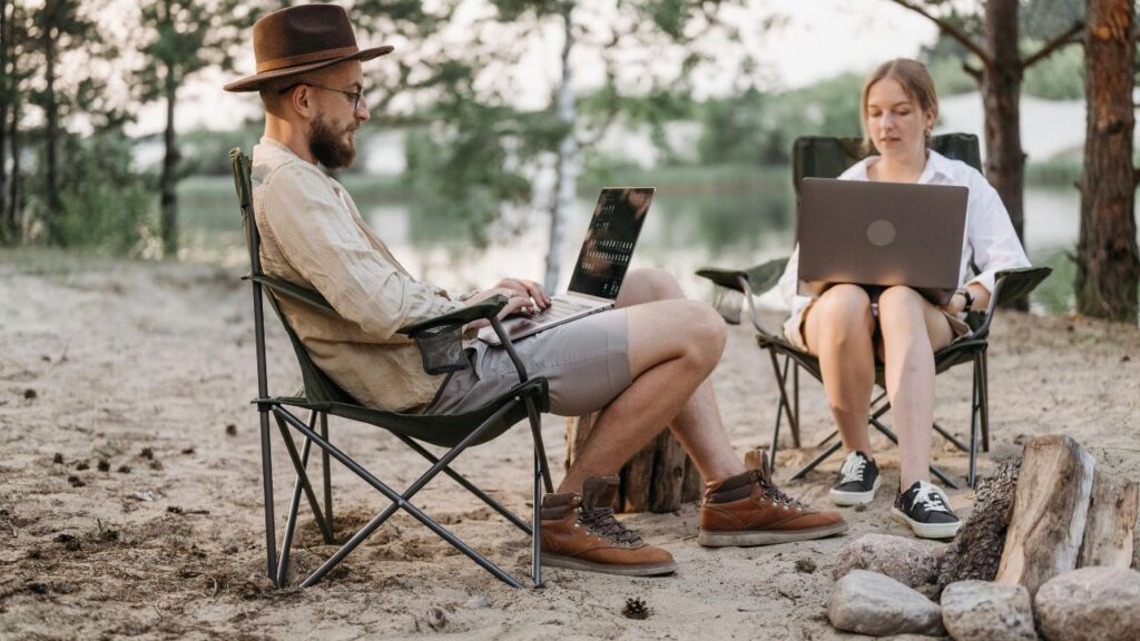 A Couple Having Conversation while Working at the Campsite