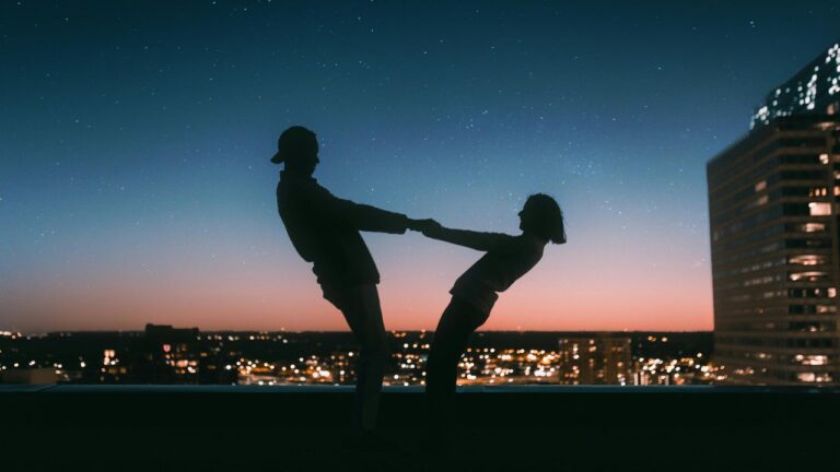 Silhouette of Man Jumping on Field during Night Tim