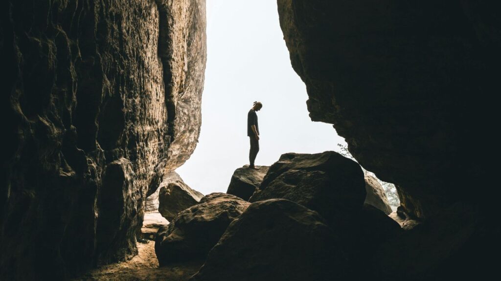 Person Standing on Rock Formation