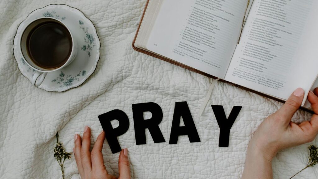 A Person Reading a Book Beside the Black Text and Coffee