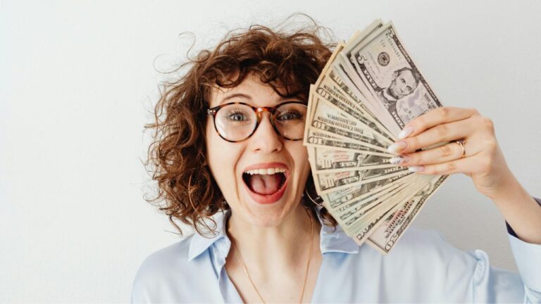 Happy Woman in Blue Long Sleeve Blouse Holding Money