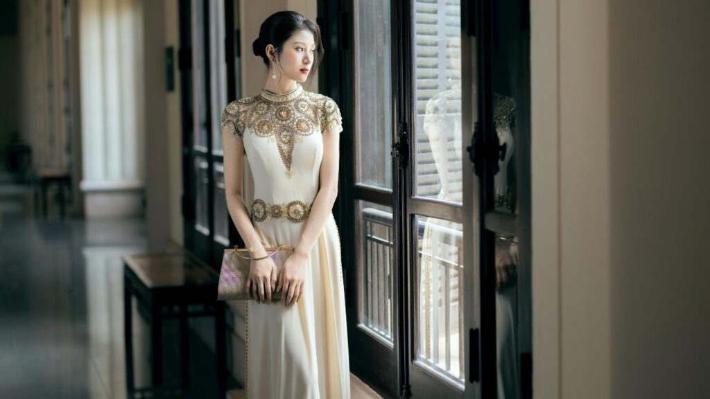 Elegant Woman in Decorative Gown by Window