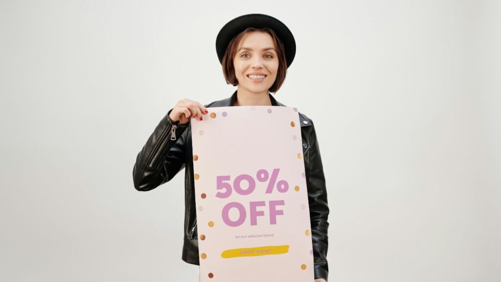 A Woman in Black Leather Jacket Holding a Poster