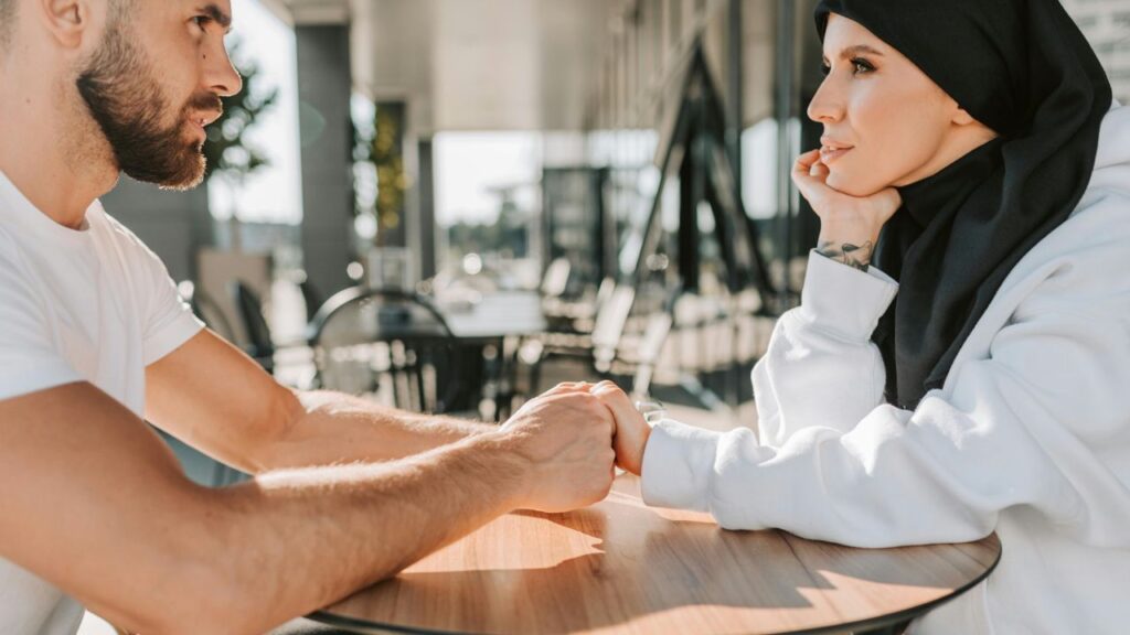 Man in White Shirt Holding the Hand of a Woman in White Jacket