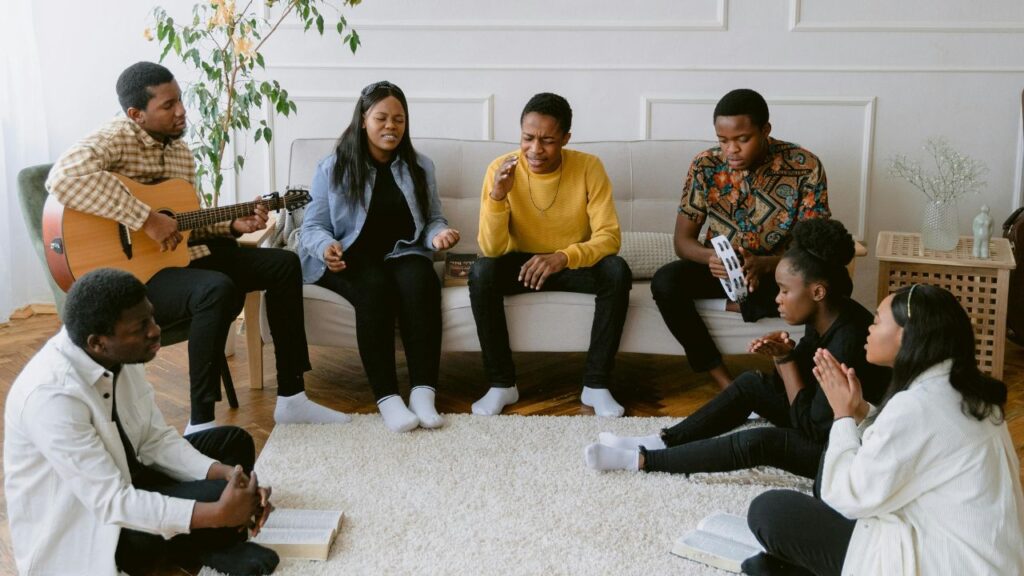 A Group of People Singing in a Room