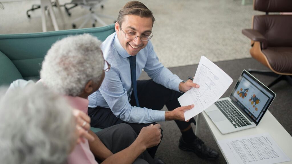An Agent Showing Documents to an Elderly Man