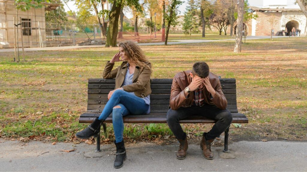Woman And Man Sitting on Brown Wooden Bench
