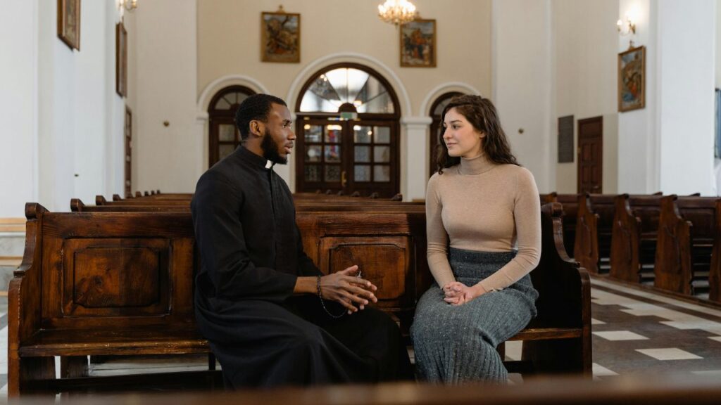 Man and Woman Sitting on Brown Wooden Bench