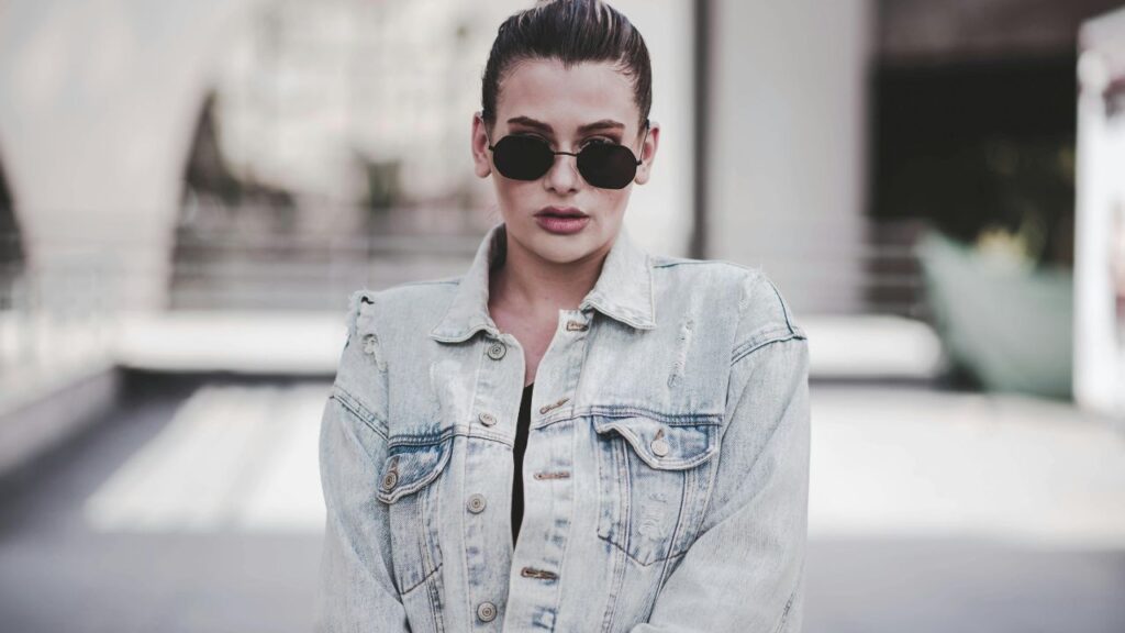 Woman Wearing Grey Denim Jacket Surrounded by White Building