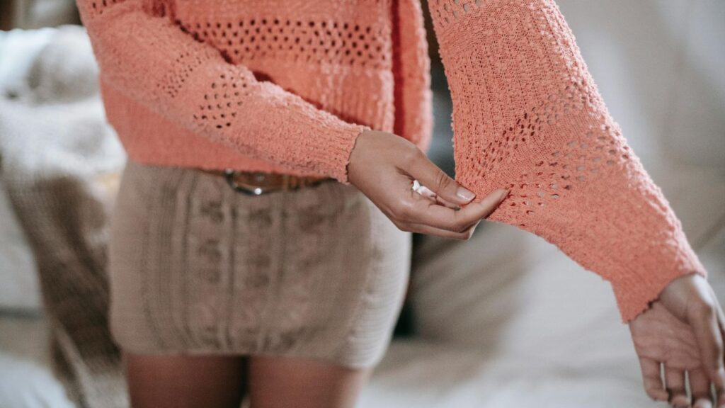 Ethnic woman showing casual knitted sweater