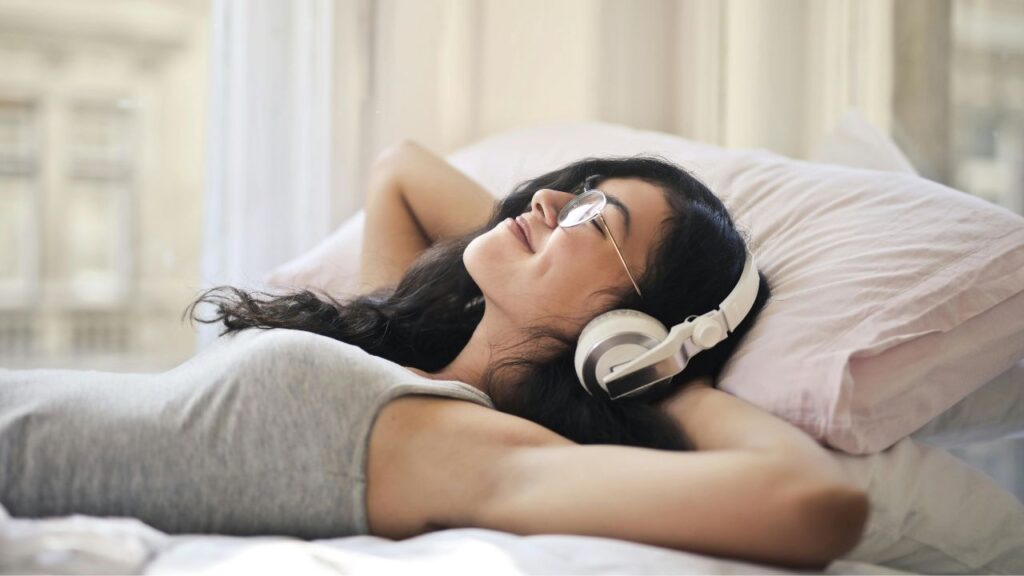 Woman in Gray Tank Top Lying on Bed