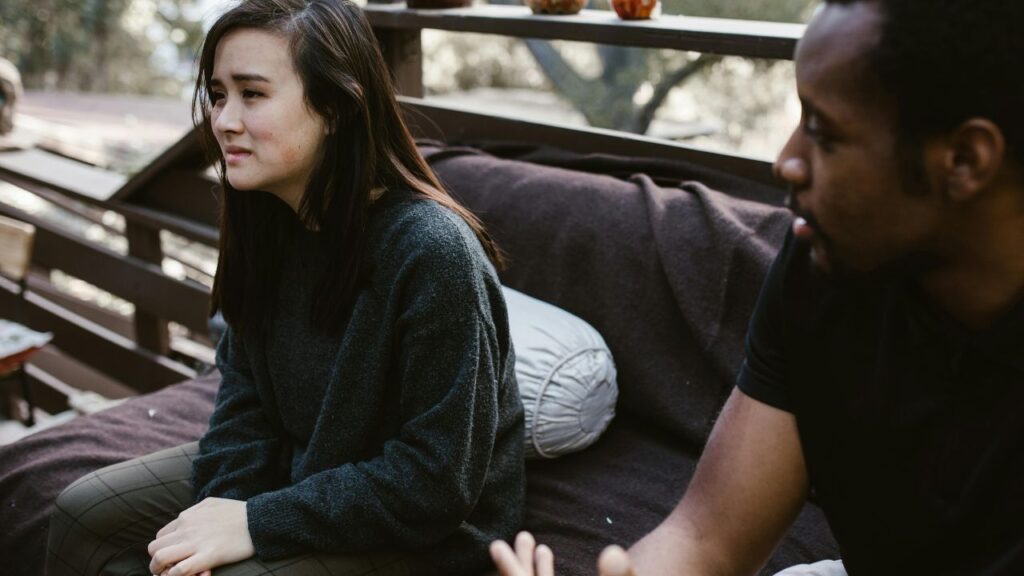 Man Sitting Beside the Crying Woman