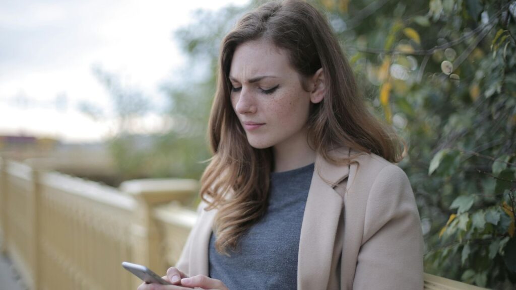 Pensive Woman in Using Smartphone
