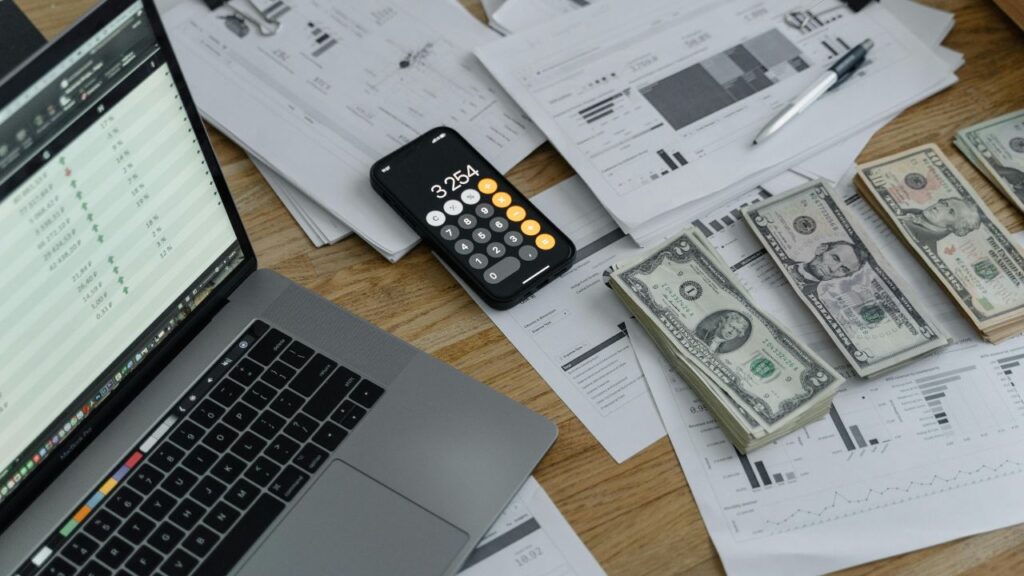 Banknotes and Calculator on Table