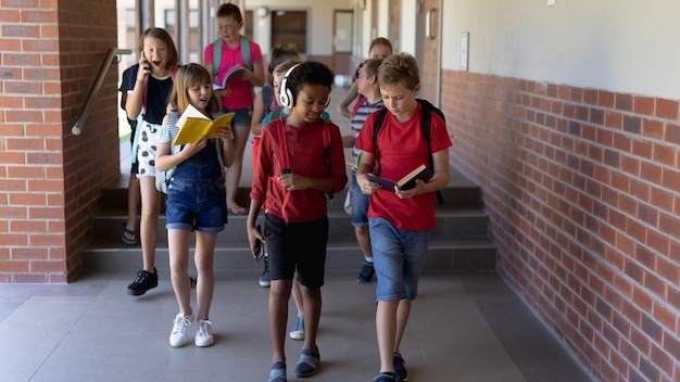 Group of school pupils walking in an outdoor corridor at elementary school