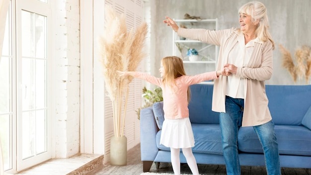 Grandma with girl at home spending time together