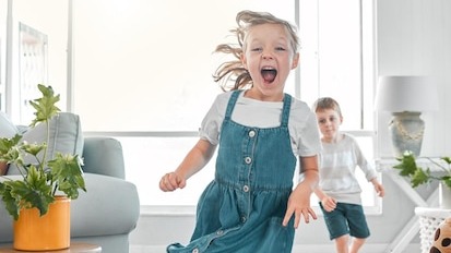 Happy children and running with portrait in home for playful fun enjoyment and bonding on weekend Excited girl and smile with game in living room for development activity and energy in house