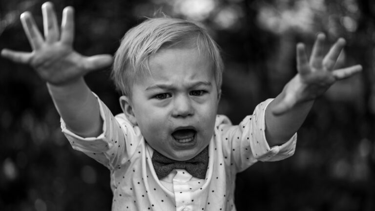 grayscale photo of girl in polka dot long sleeve shirt