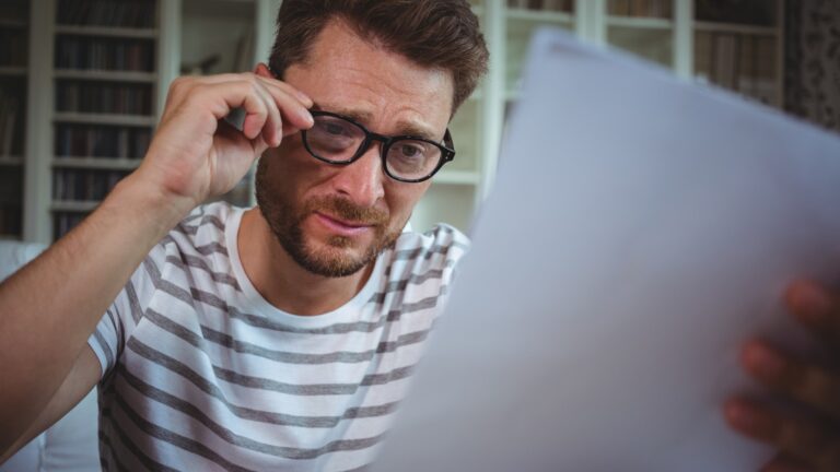 Worried man looking at his bills