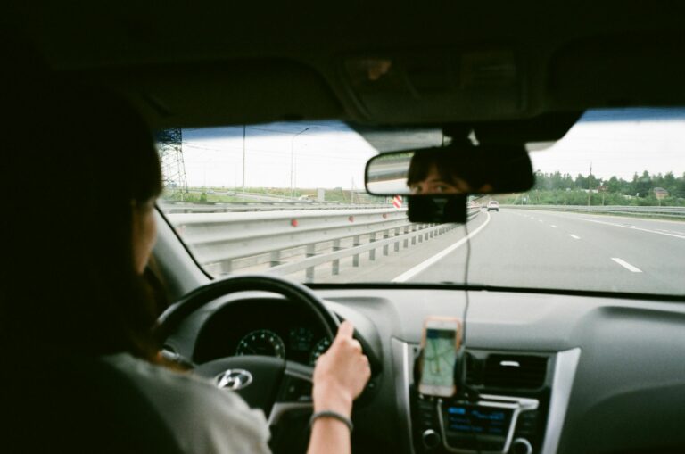 woman driving car on toll road