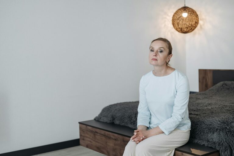 sad woman sitting in empty bedroom