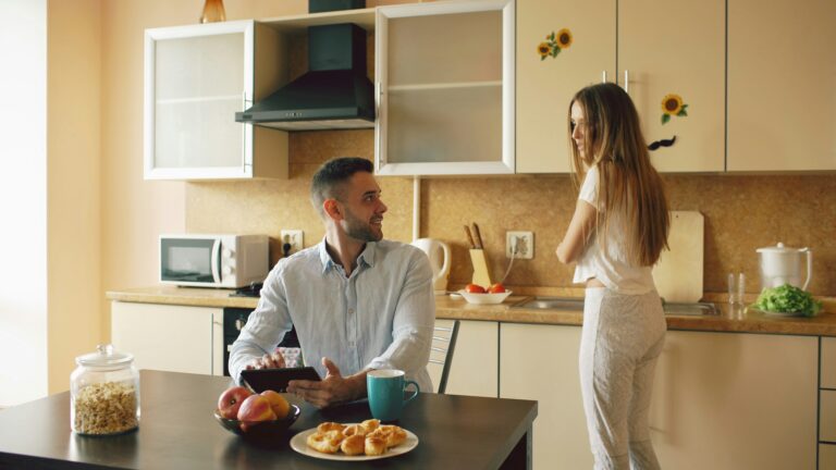 tired woman in kitchen asking husband for help