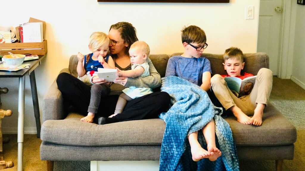 3 children sitting on gray couch