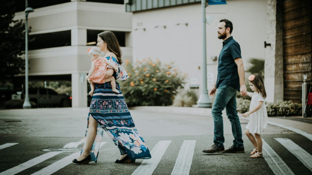 man and woman crossing road