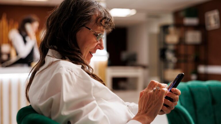 Young woman using mobile phone at home