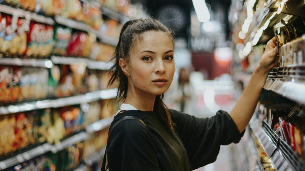 woman shopping in grocery store aisle