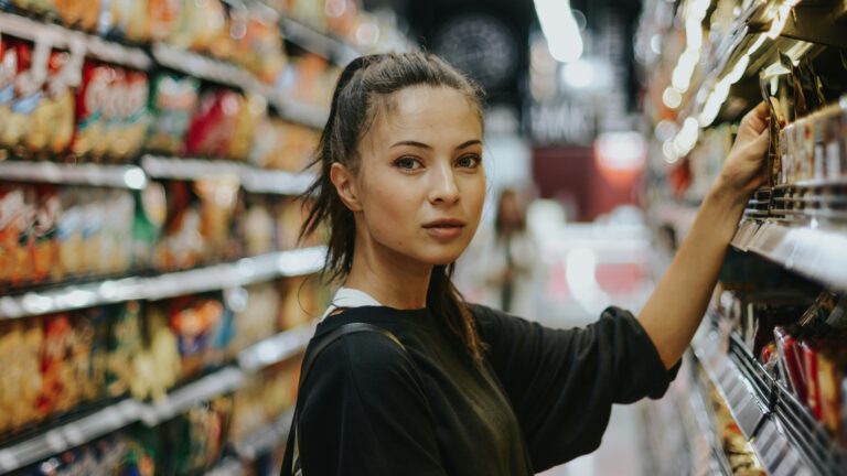 woman shopping in grocery store aisle