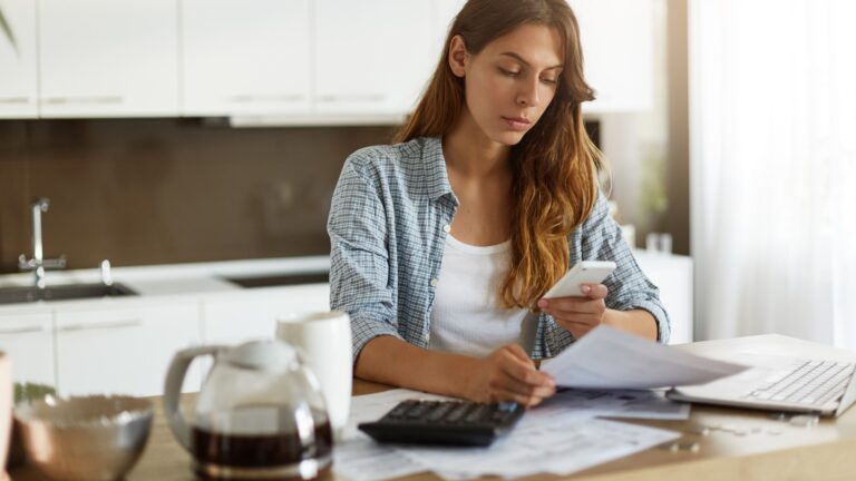 Young woman checking her budget and doing taxes