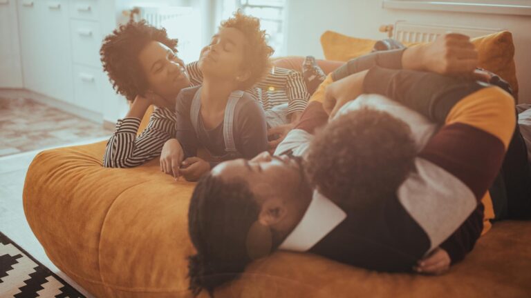 Happy family relaxing on the sofa together at home