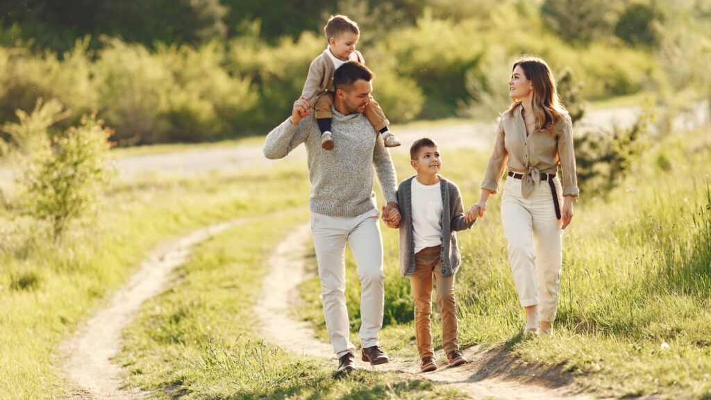 Cute family playing in a summer field
