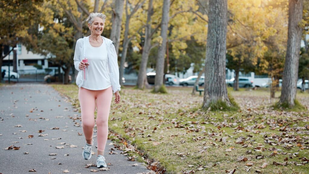 Health nature and senior woman on walk in the morning for exercise wellness and fitness in park Healthy outdoor and elderly lady in retirement from Australia walking in garden for cardio workout