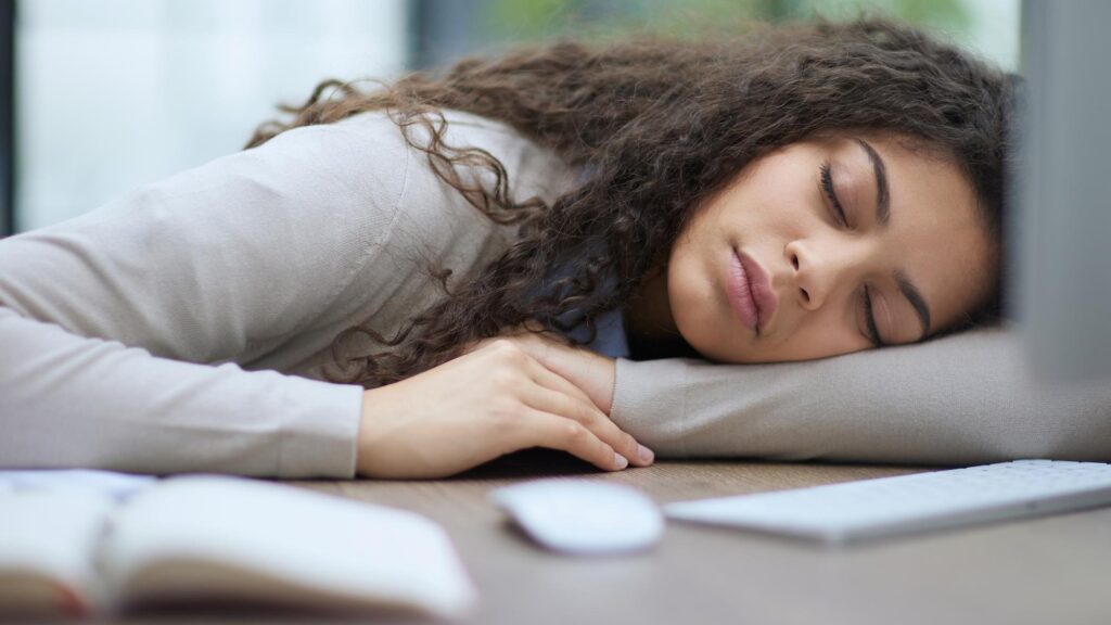 Tired overworked woman resting at workplace in office