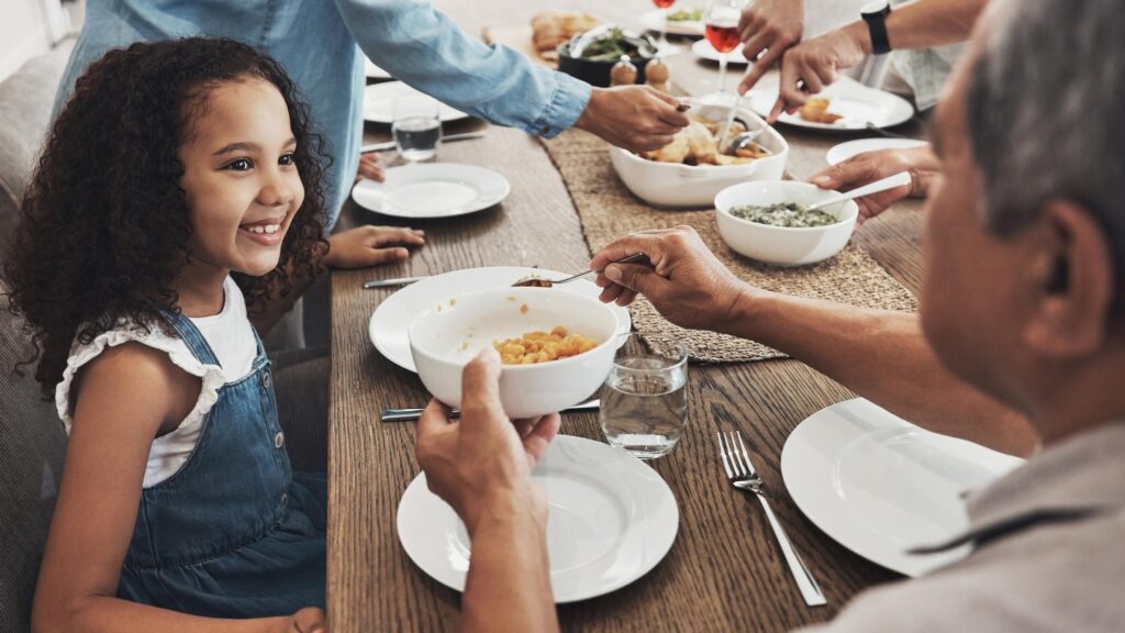 Food family and grandfather with child for holiday celebration Christmas and nutrition Happy kid with senior man or person with lunch help love and care in Mexico home and dining room