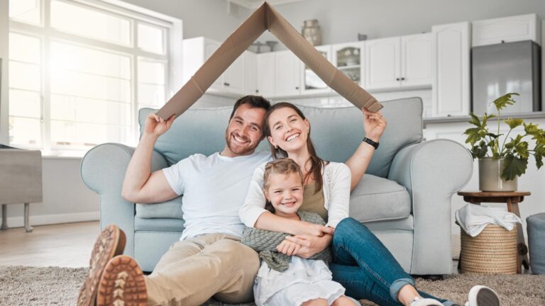 Happy family portrait and roof with daughter for safety security or property investment at home Mother father and young child or kid with smile on floor for shelter apartment or house together