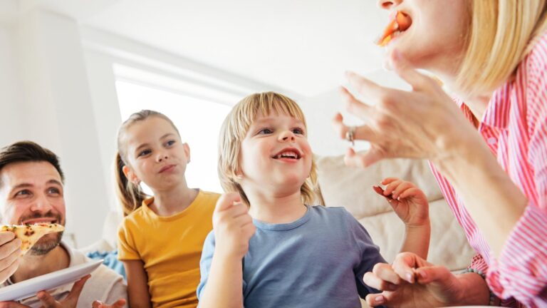Family eating pizza together and having fun bonding with each other
