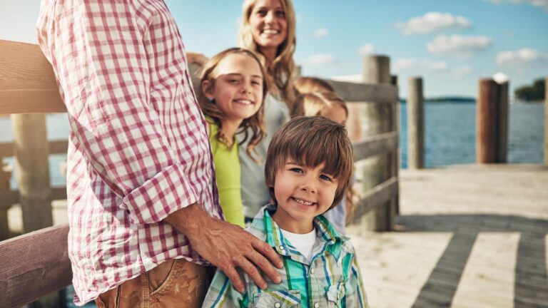 Portrait pier and family with kids smile and getaway trip for summer holiday People outdoor and siblings with happiness vacation and relax with weekend break journey and explore in Italy