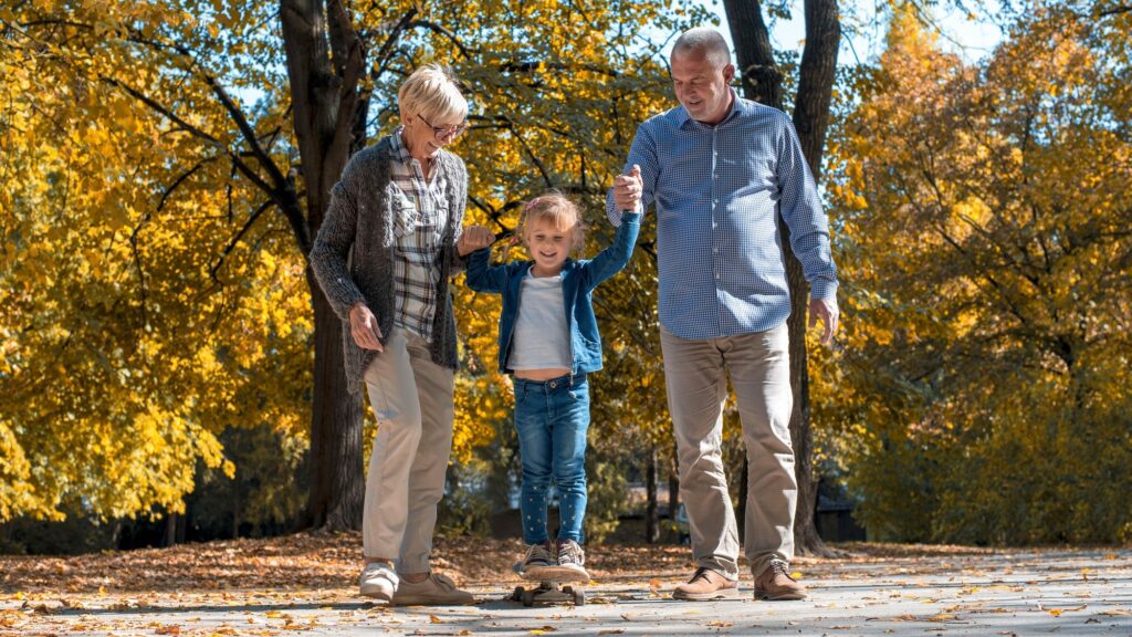 Happy grandparents playing with their grandson in the park