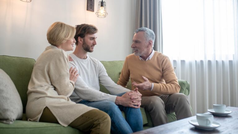 Family together. Son visiting his parents and talking to them