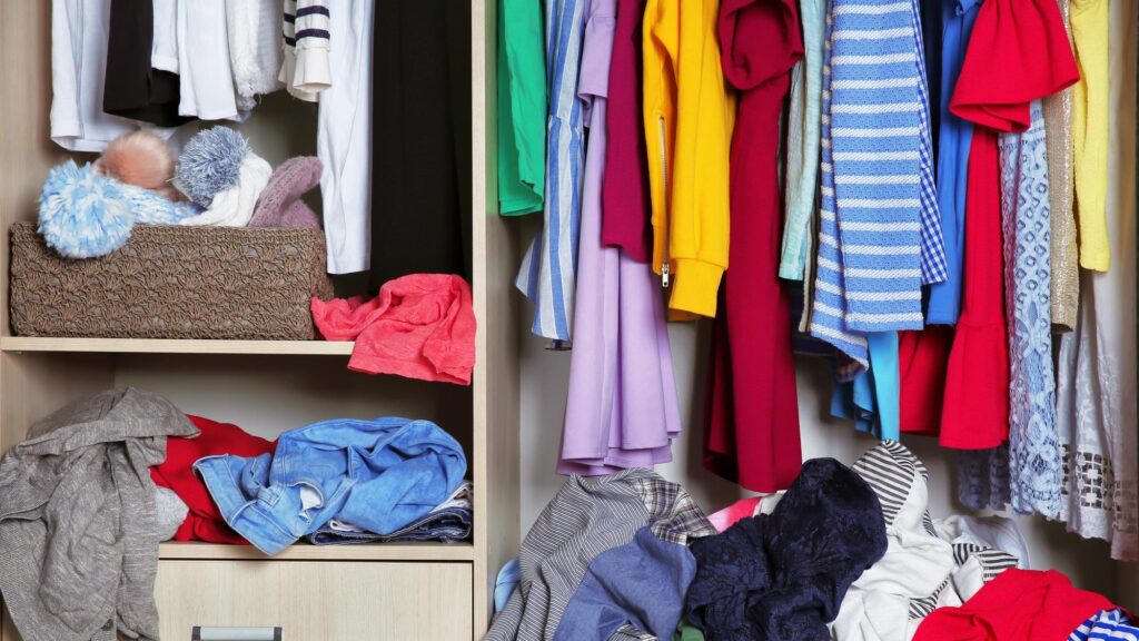 Wardrobe with messy clothes closeup