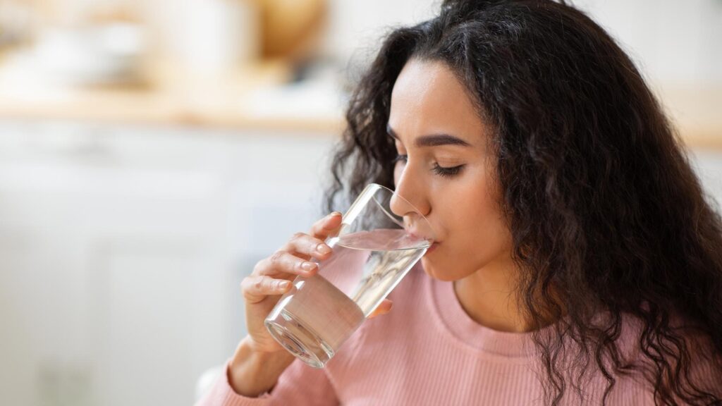 Healthy Liquid Beautiful Brunette Woman Drinking Mineral Water From Glass In Kitchen