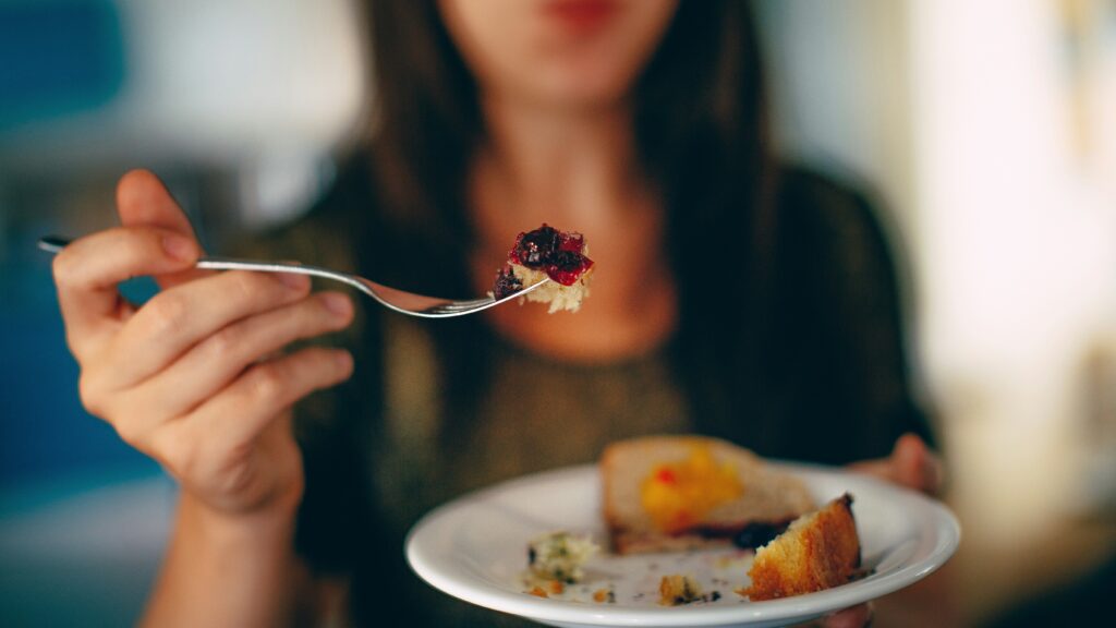 woman holding plate of cake