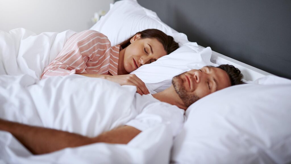 Couple home and sleeping in bed to relax for break rest and comfortable with love People relationship and dreaming in bedroom with exhaustion burnout and tired as lover in morning and cosy