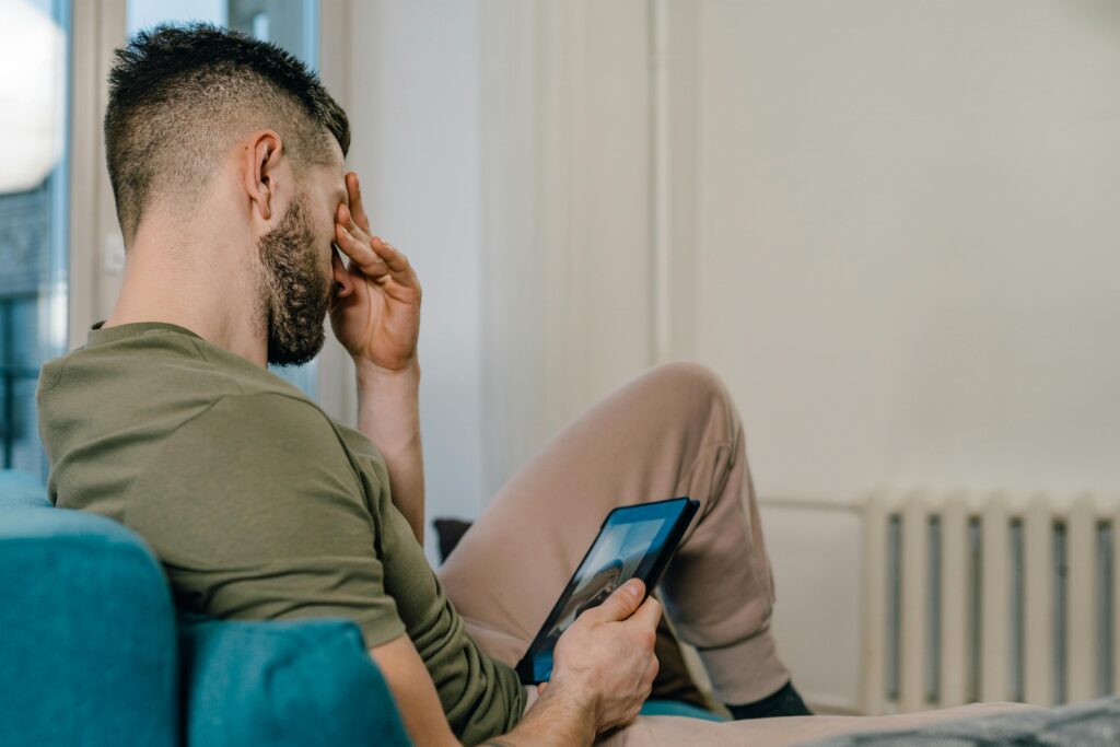 man watching old video of his children