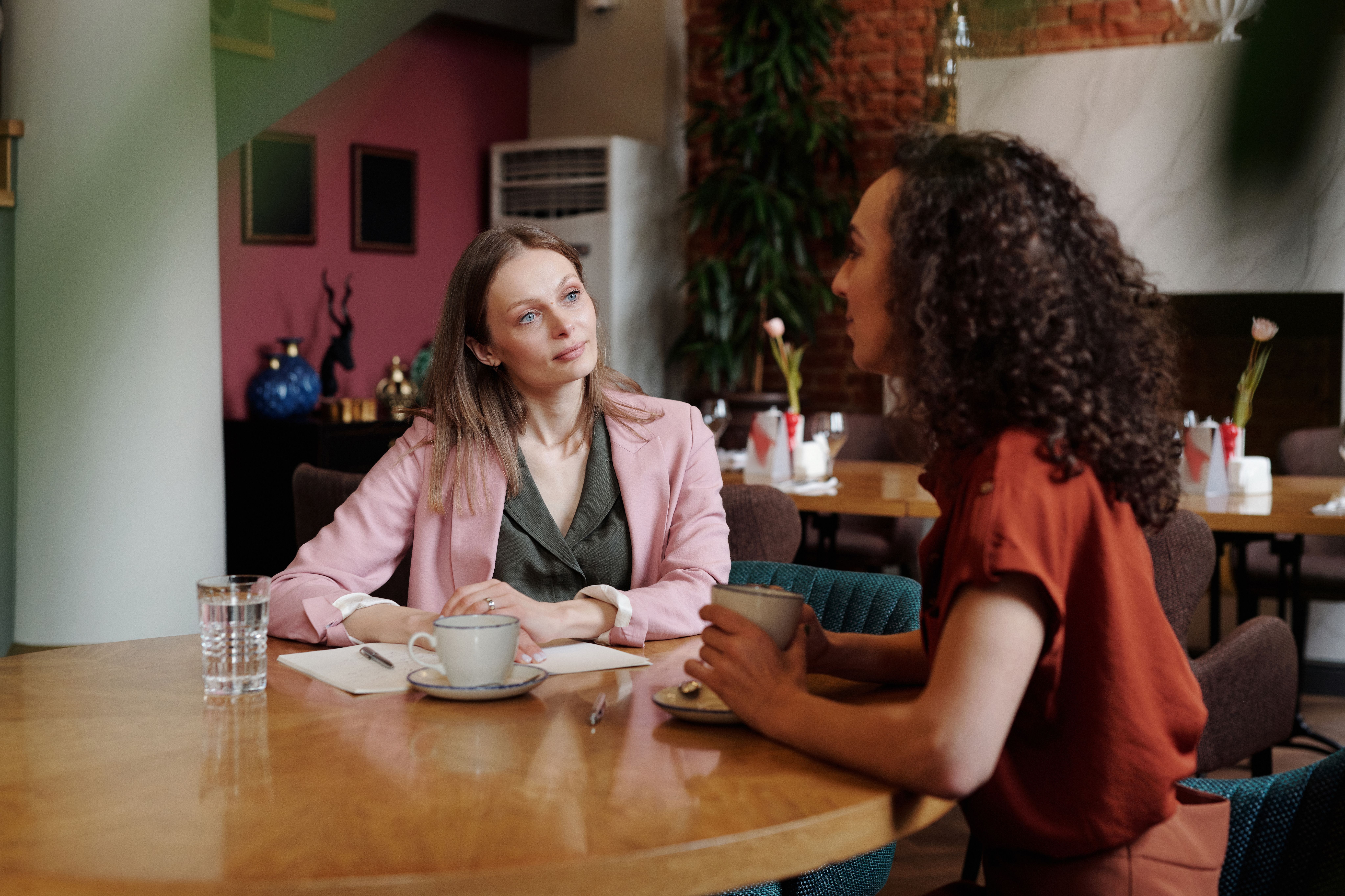 two women having coffee, talking